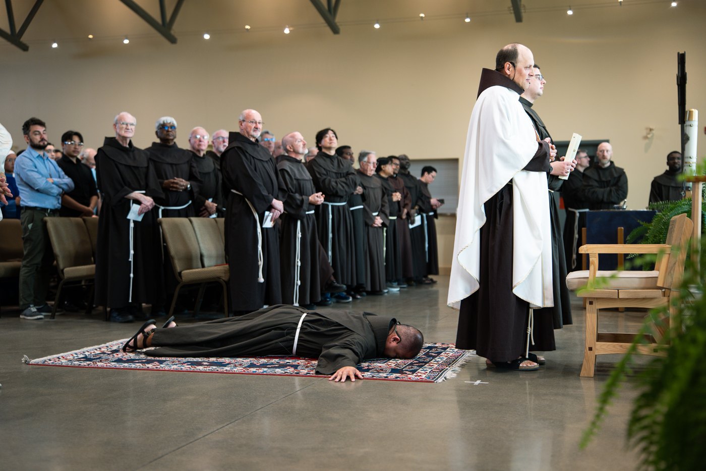 Aldin lies prostrate during the solemn-profession liturgy