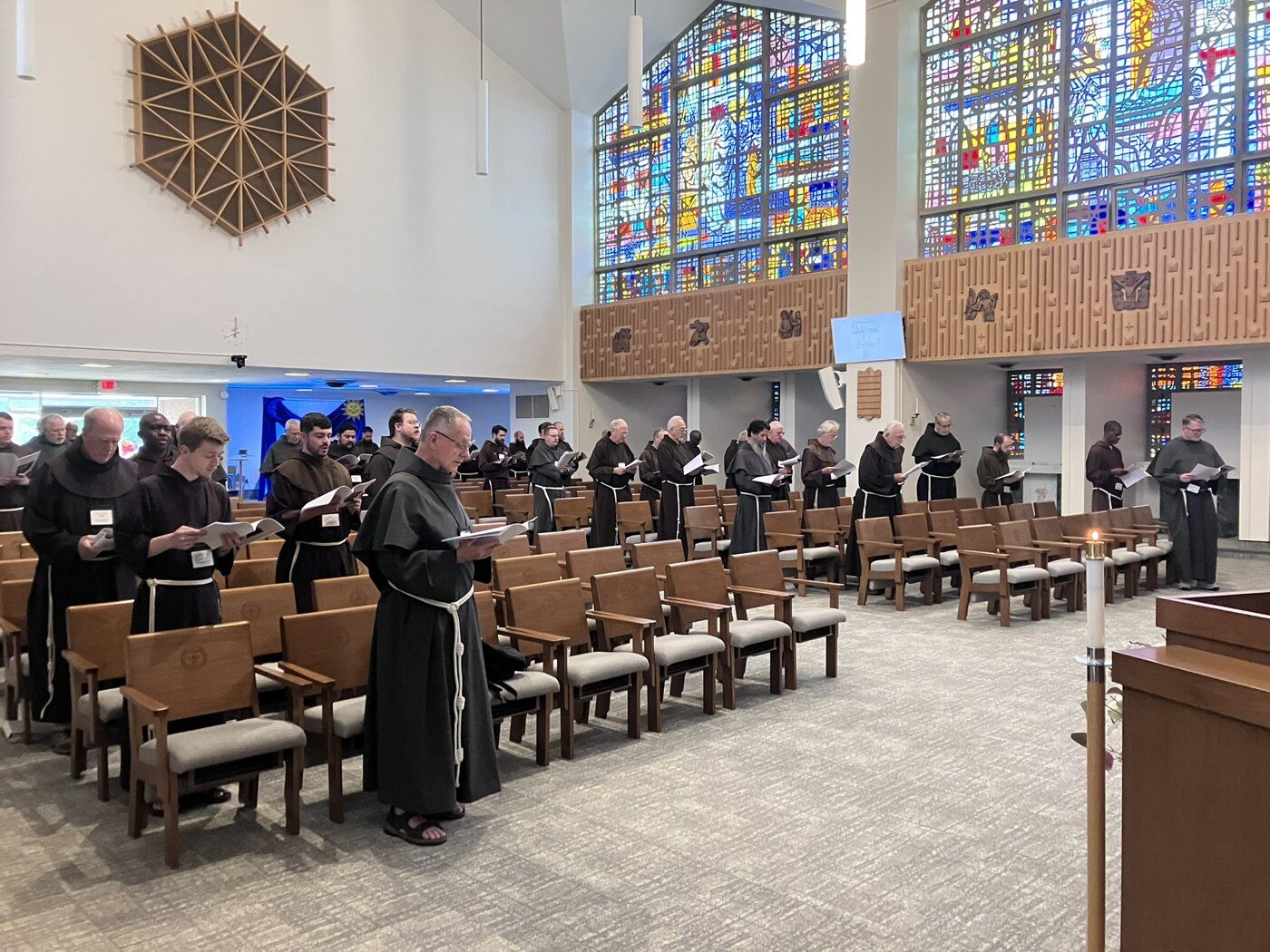 Franciscan friars pray in the university chapel